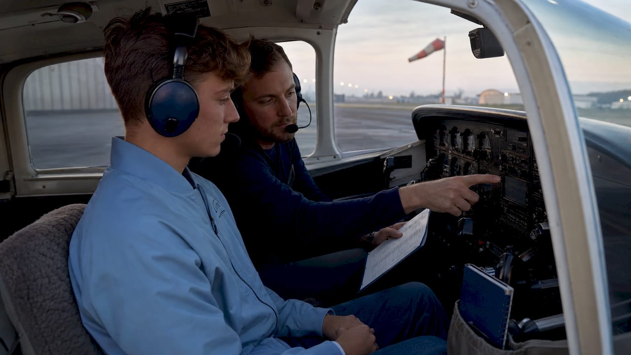 Student pilot training in small aircraft cockpit