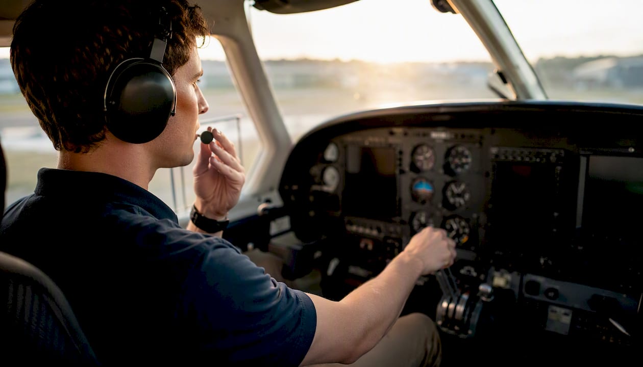 Pilot practicing emergency procedures in cockpit