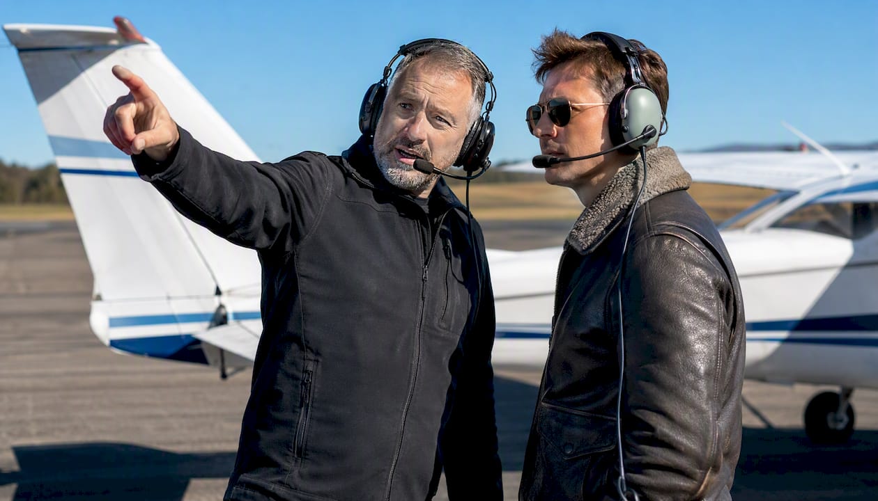 Flight instructor guiding student pilot outdoors