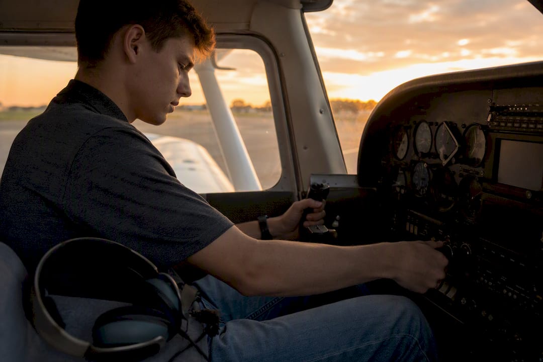 Pilot performing cockpit controls during flight training