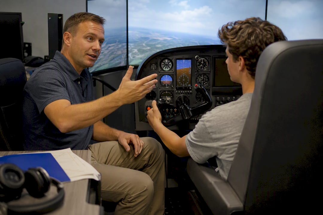 Instructor guiding student in flight simulator