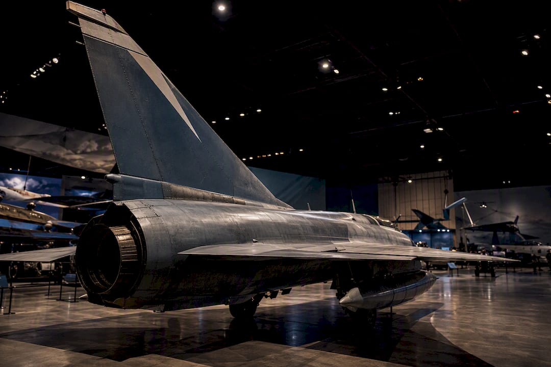Display of military fighter jet inside museum hangar