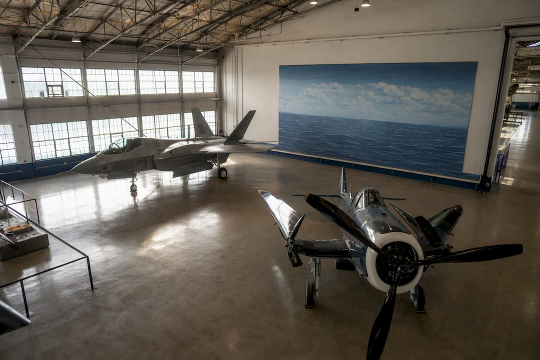 Historic and modern naval planes exhibited in museum hangar