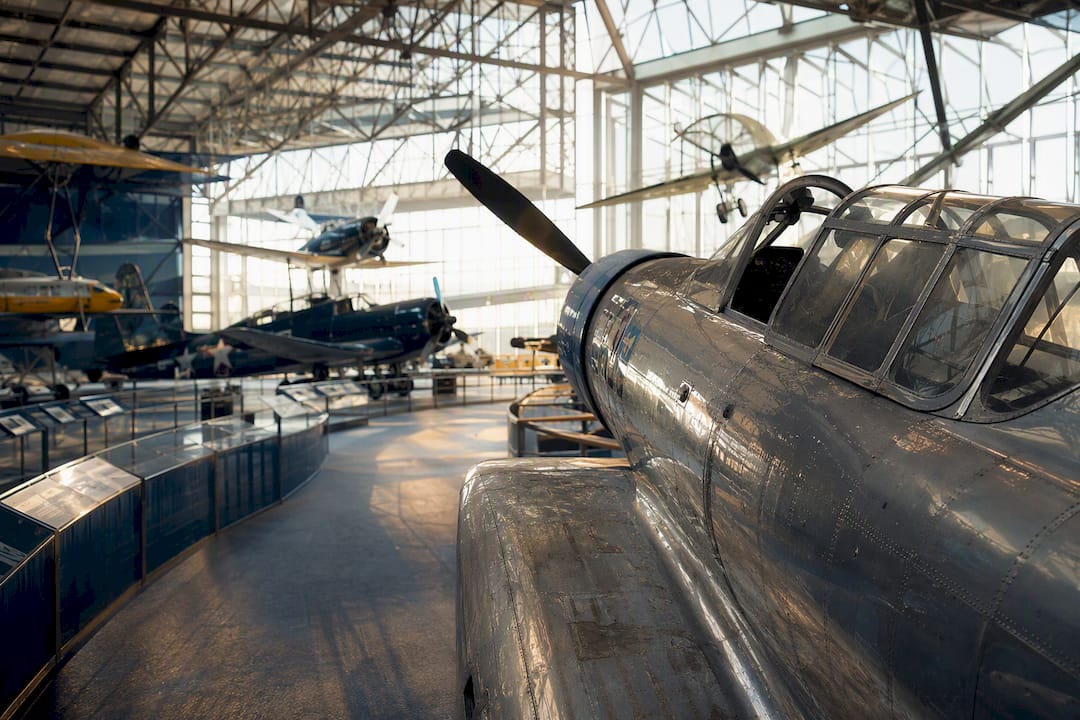 Historic airplanes displayed inside aviation museum hangar
