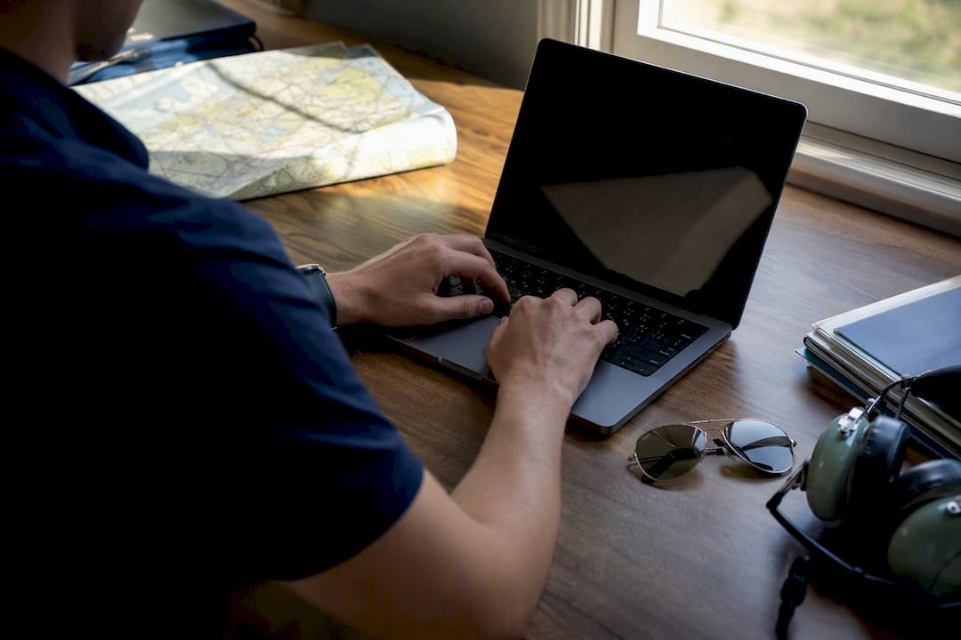 Pilot filling scholarship application at desk
