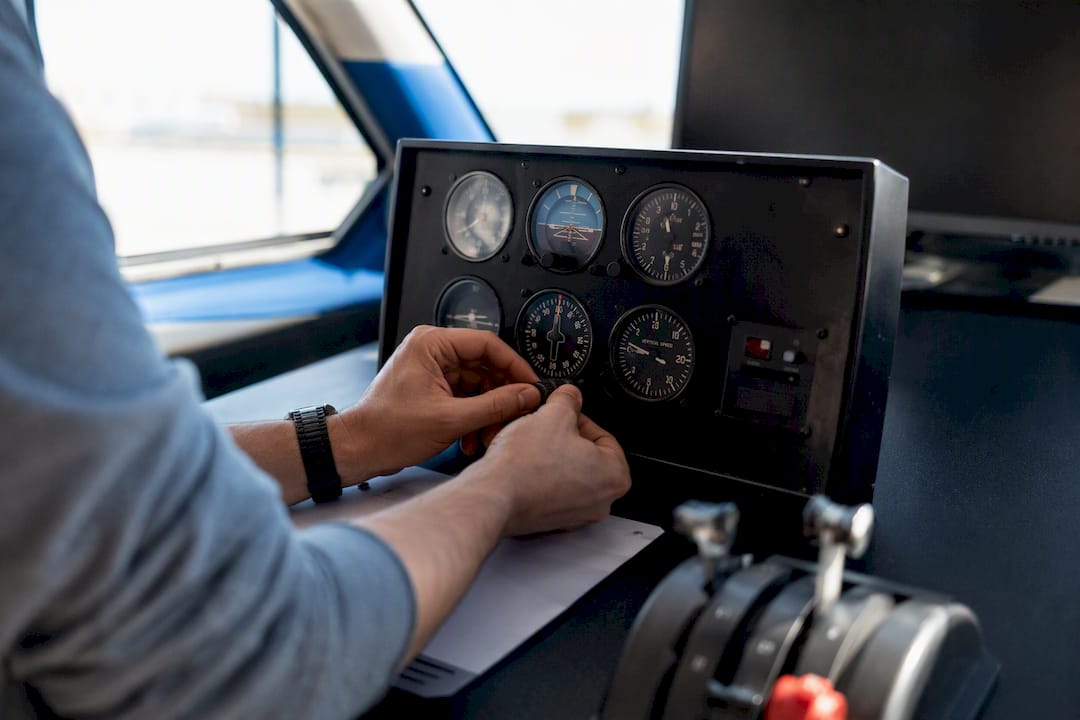 Pilot hands adjusting flight instrument