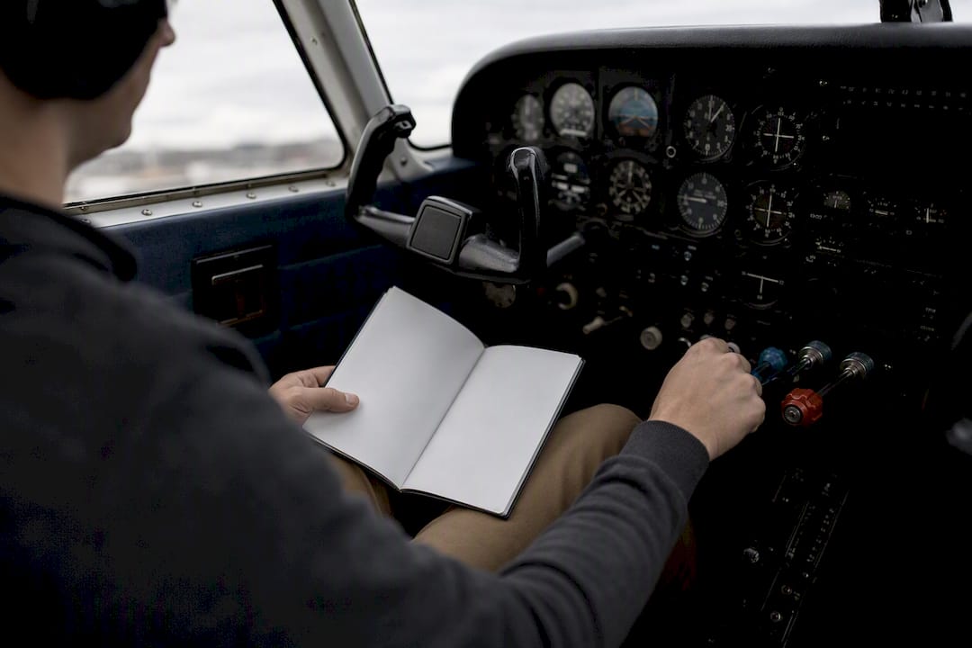 Pilot hands holding emergency checklist inside cockpit