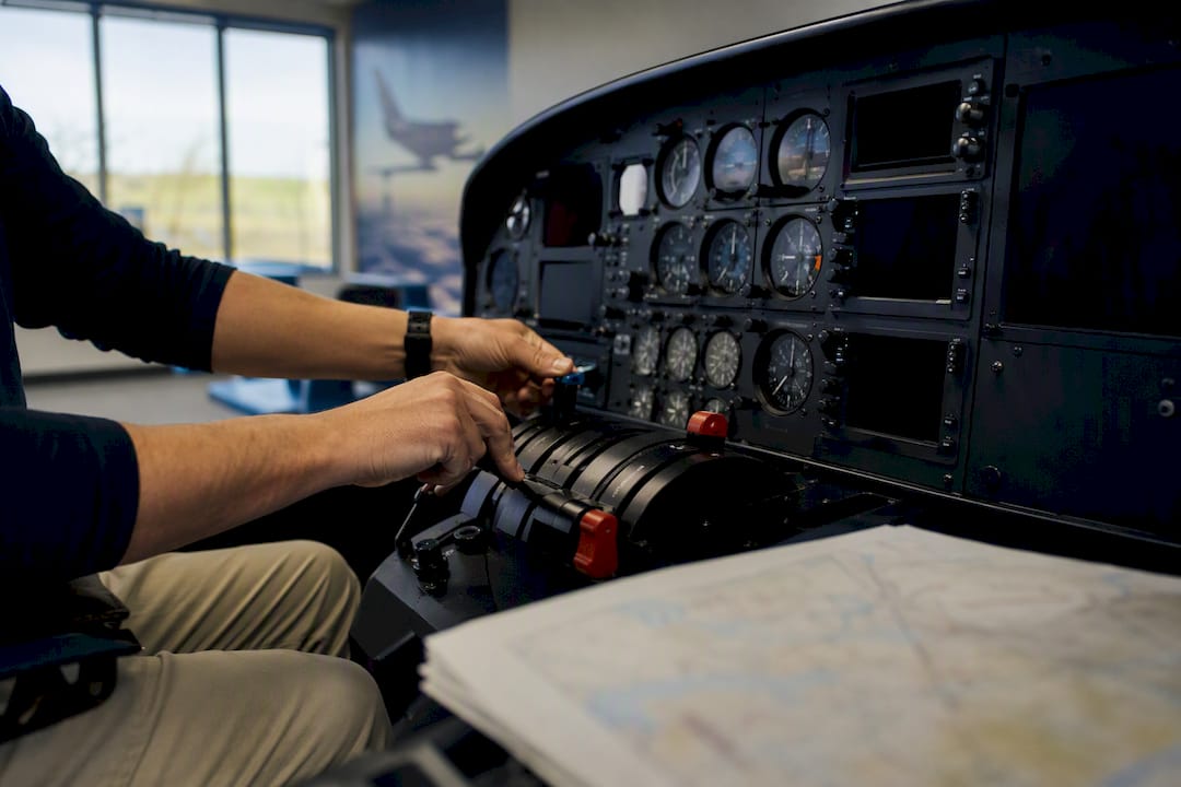 Pilot hands adjusting aircraft engine controls