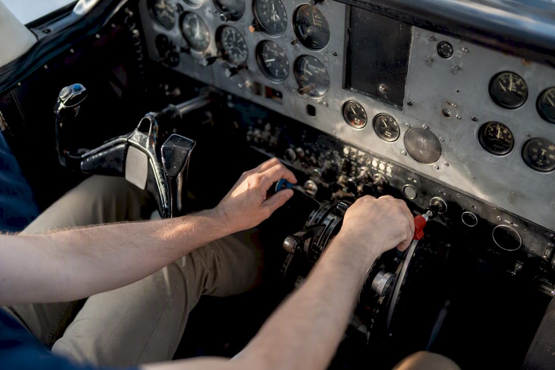 Pilot hands adjusting multiple engine controls