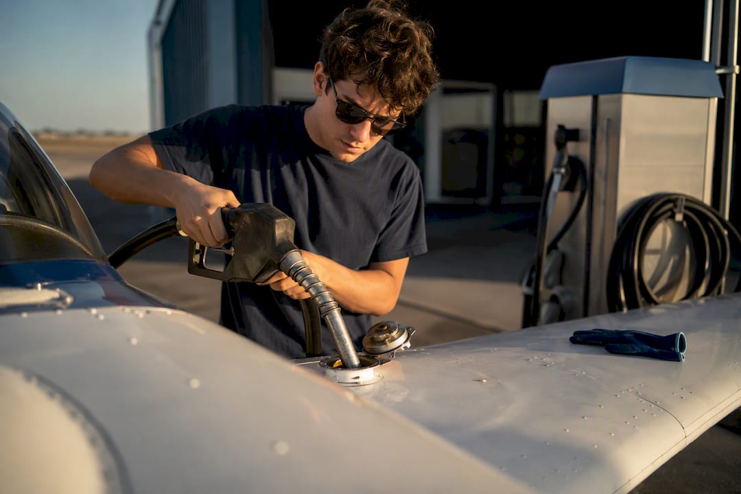 Student pilot fueling an aircraft at a fuel island
