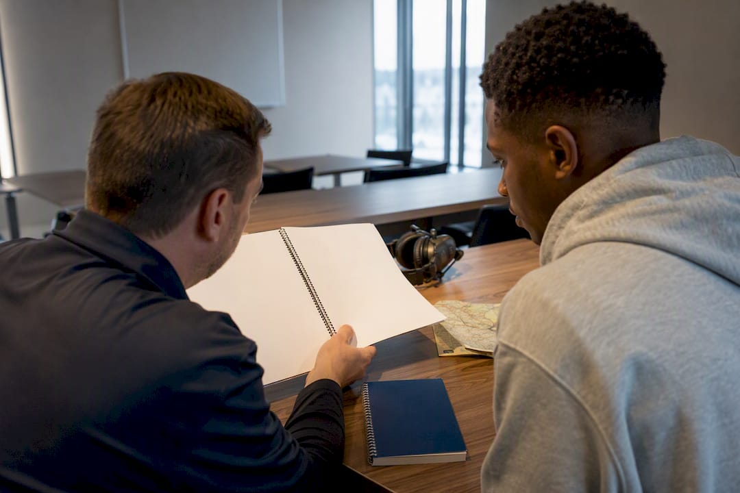 Instructor and student reviewing a flight syllabus