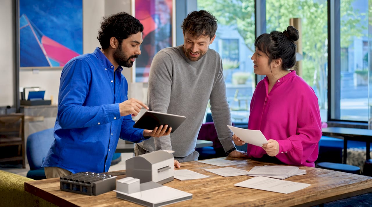 Team reviewing digital and paper invoices