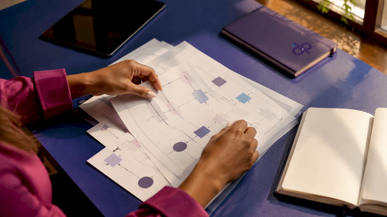Close-up of hands adjusting document workflow diagrams