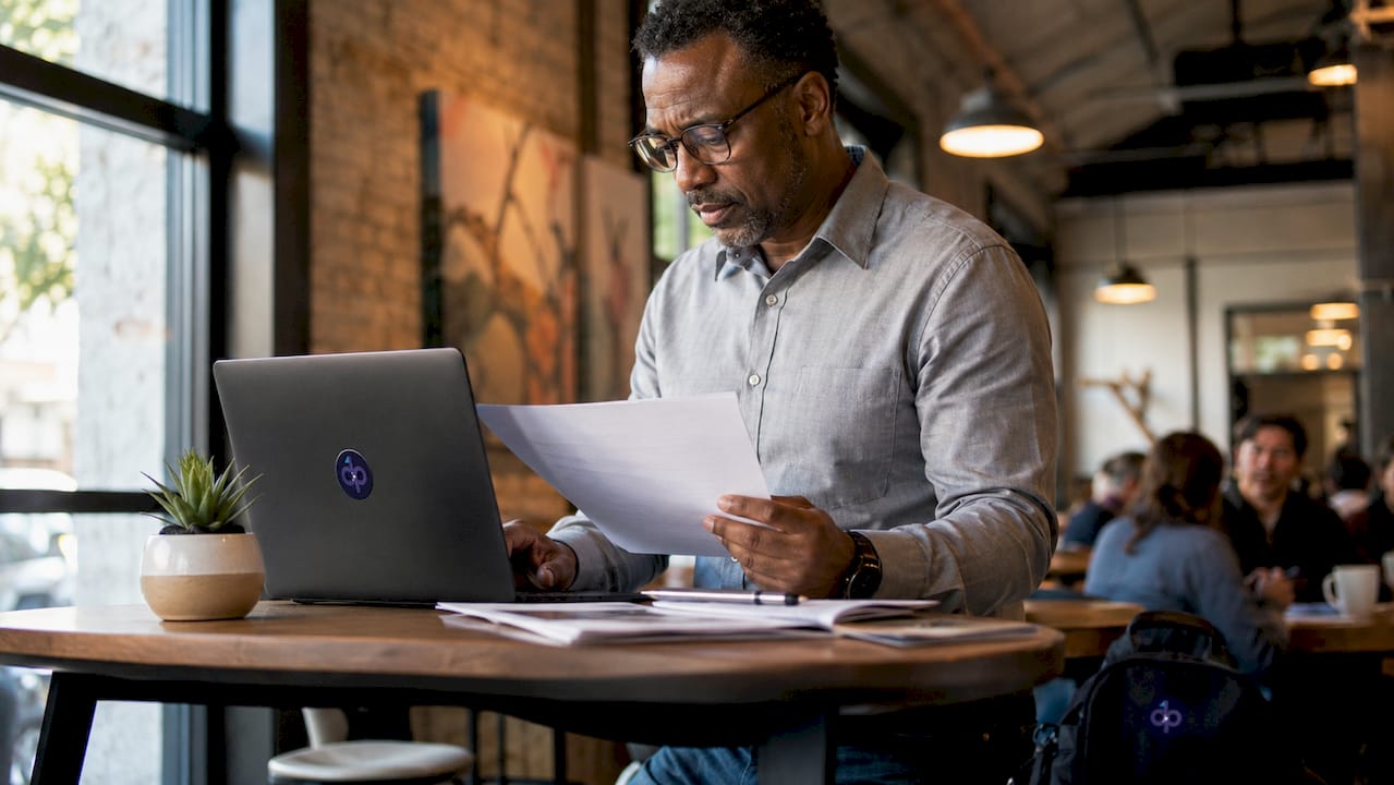 Man reviewing document automation workflow at laptop