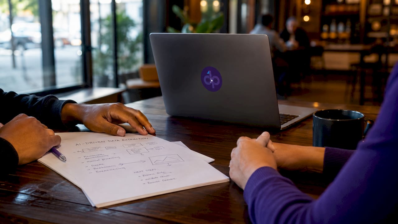 Hands typing on laptop keyboard with tech workspace details