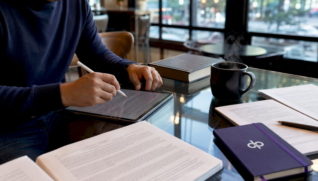 Hands highlighting text on legal documents