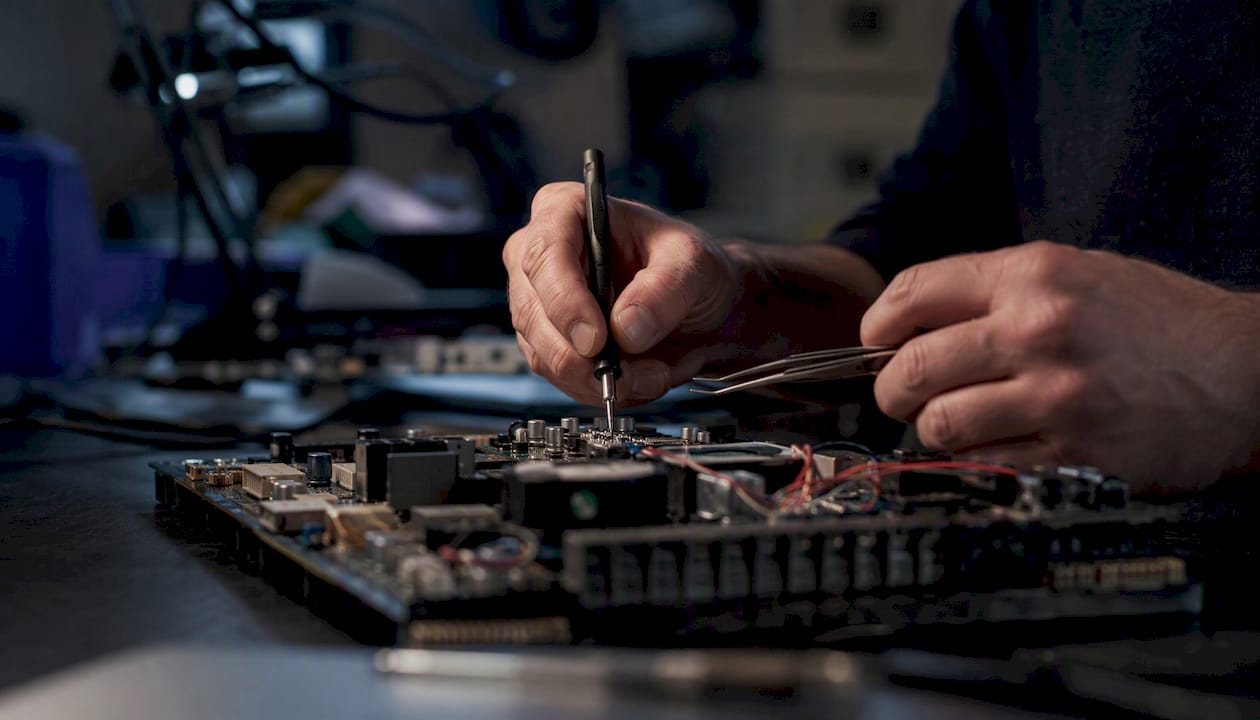 Engineer hands troubleshooting circuit board