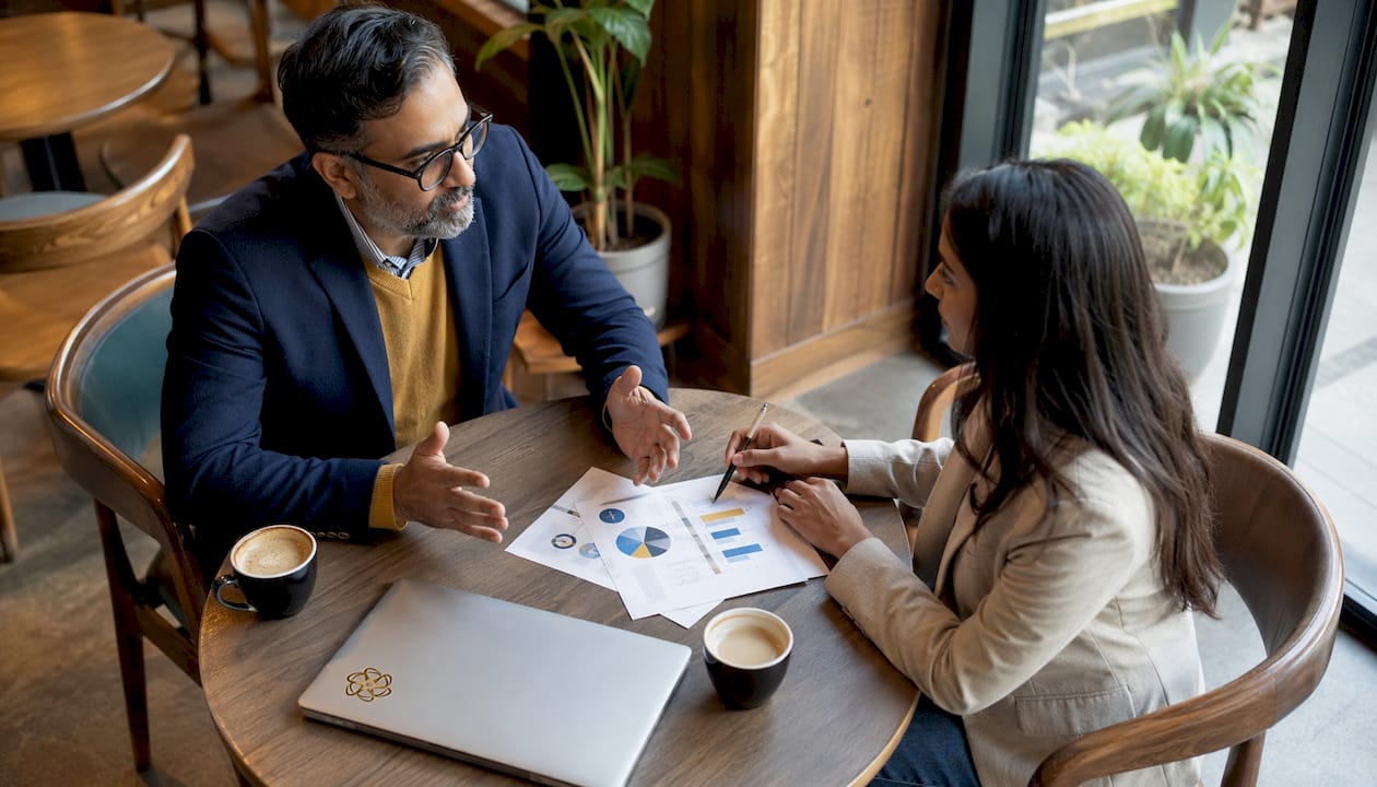 Business team discussing delayed decisions at conference table