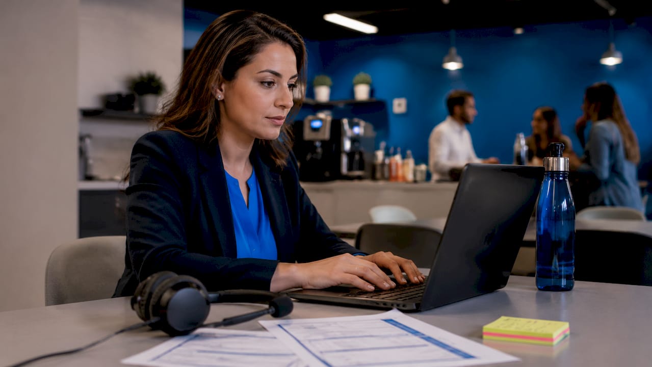 Woman typing on laptop in office