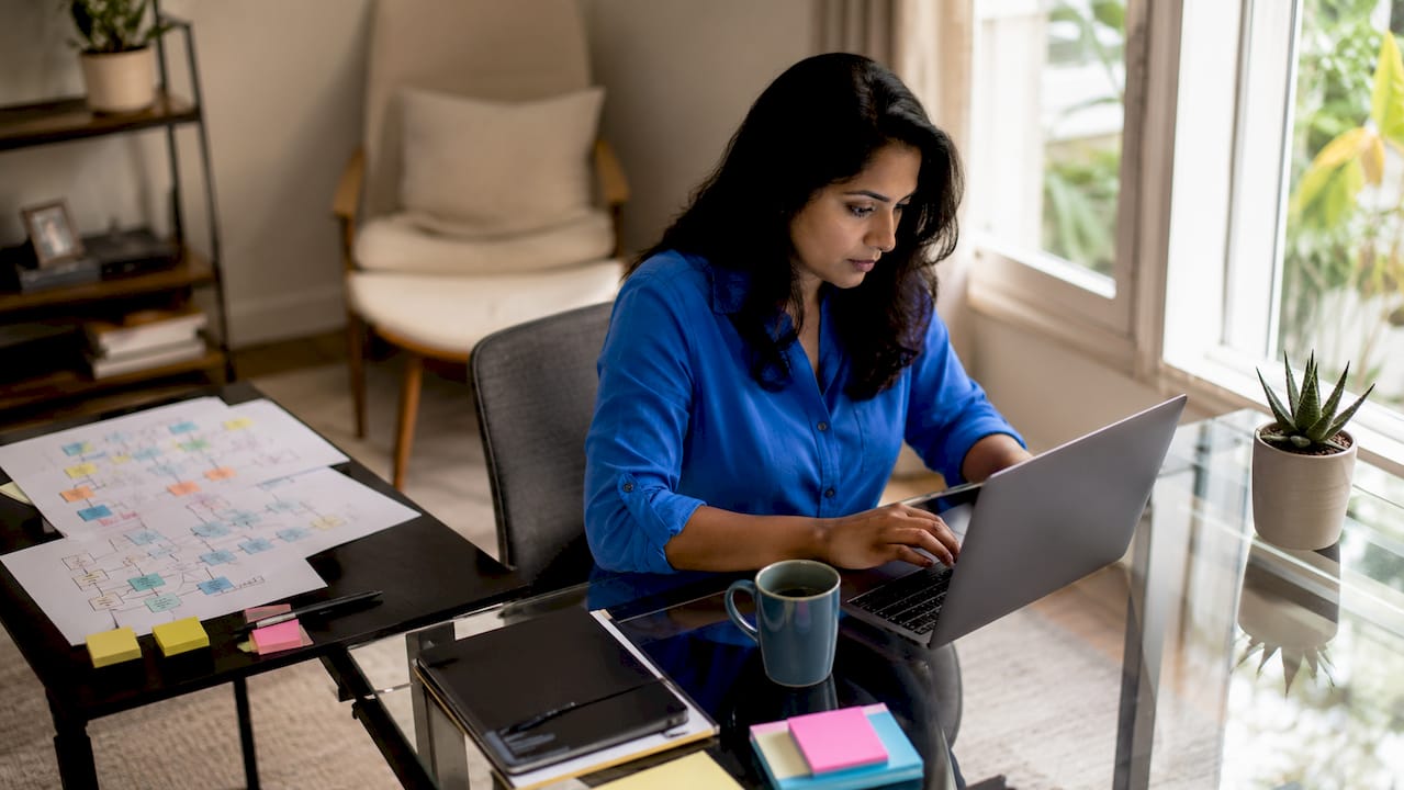 Startup founder working on automation workflows at desk