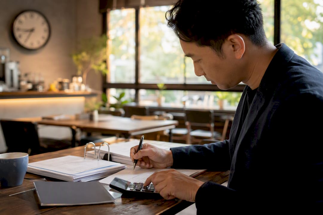 Hands adjusting payment schedules in office