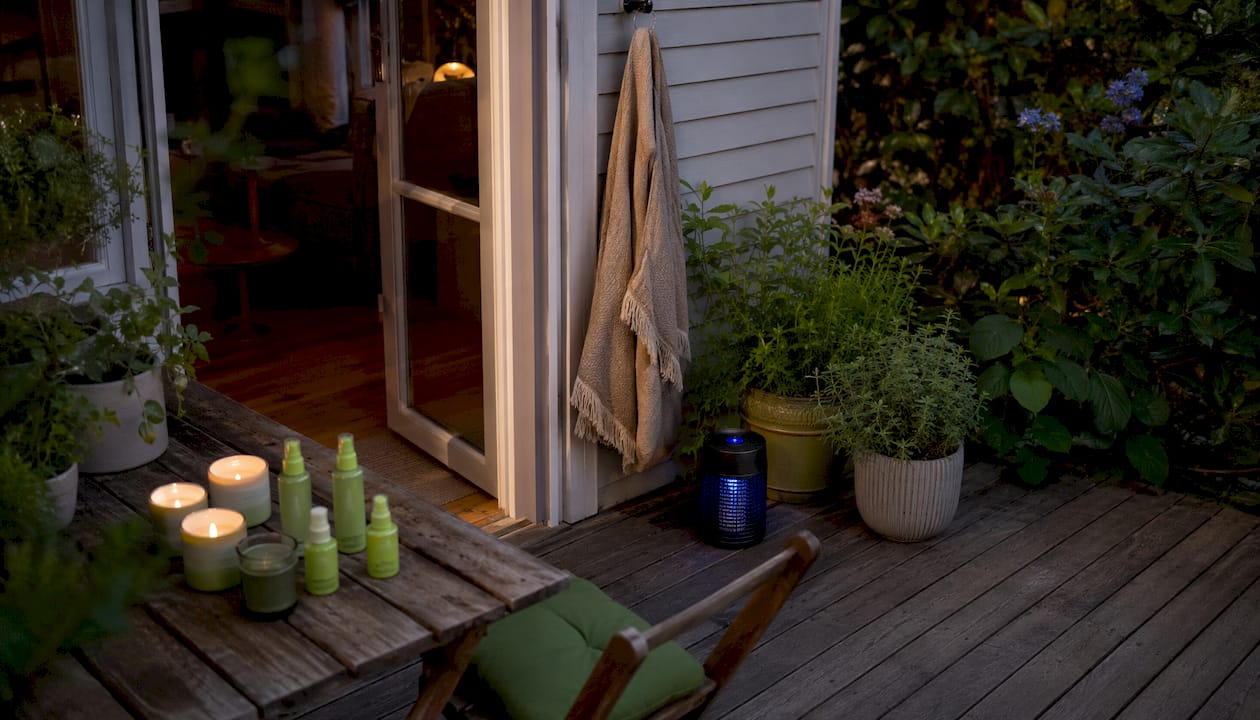 Mosquito prevention products on porch at dusk