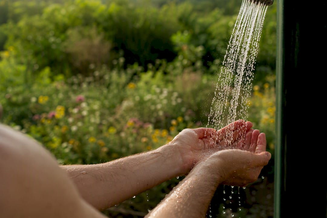 Hands rinsing with cool water after shaving
