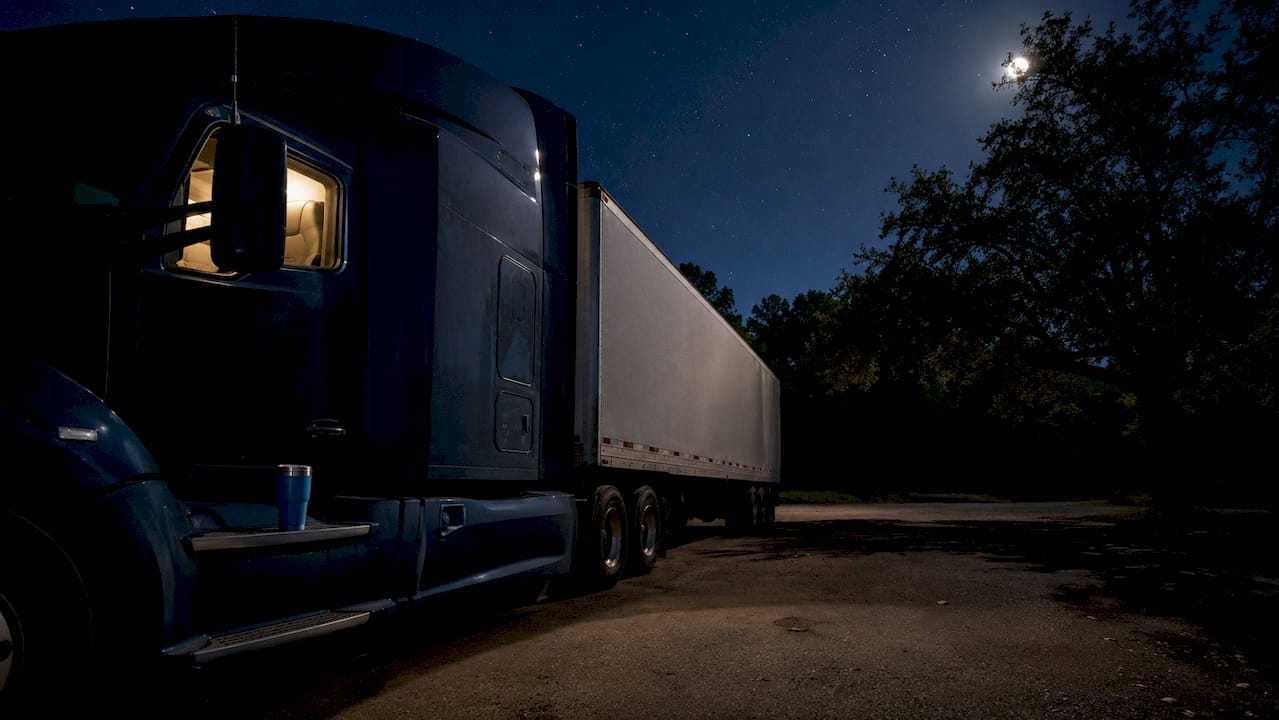 Parked truck sleeper softly lit at night