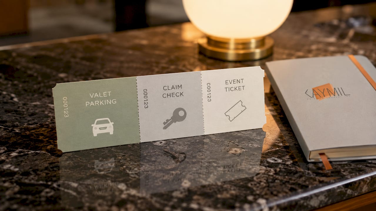Three-part event parking ticket on wooden table