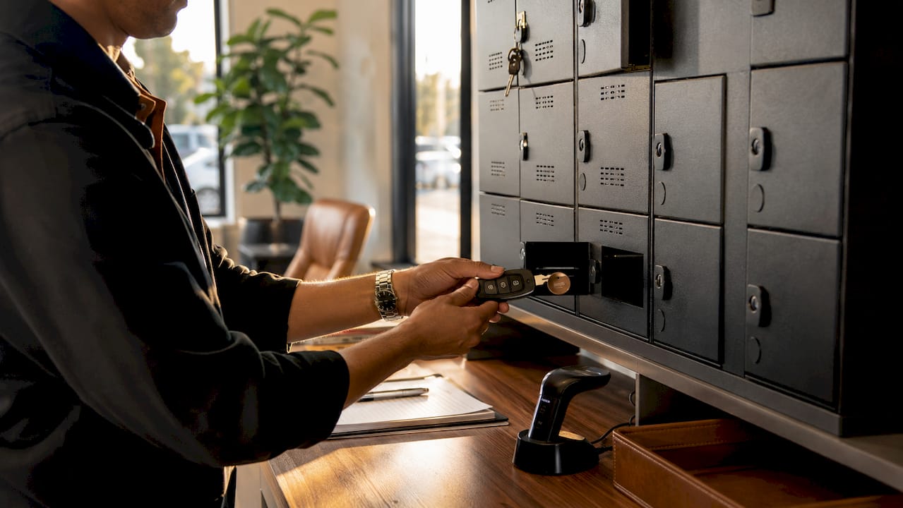 Close-up of valet hands managing RFID key storage