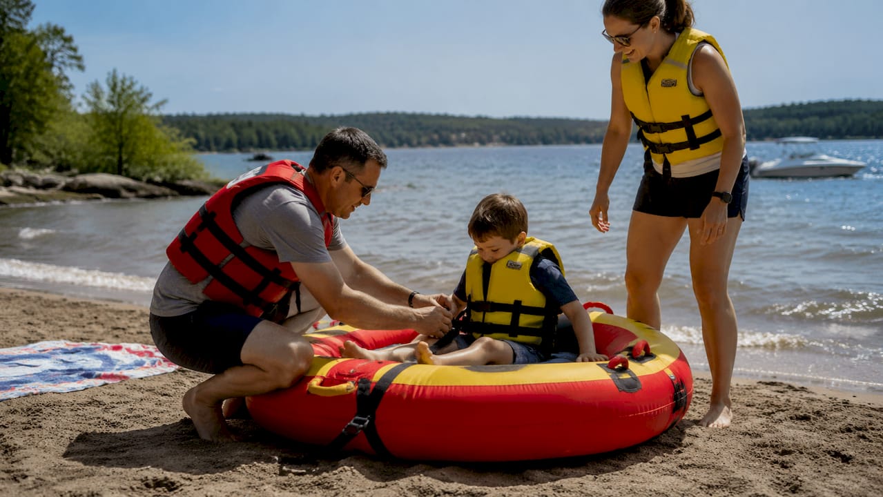 Group preparing inflatable tube at dock