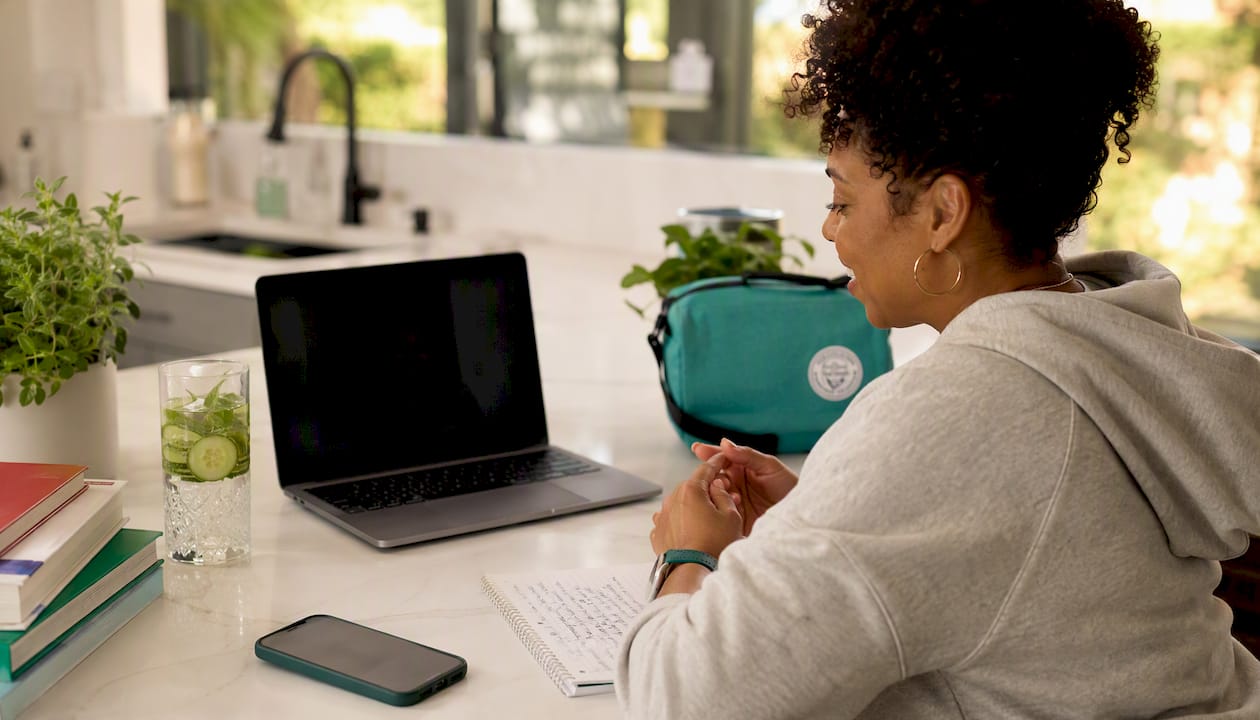 Woman having online weight loss coach session at home