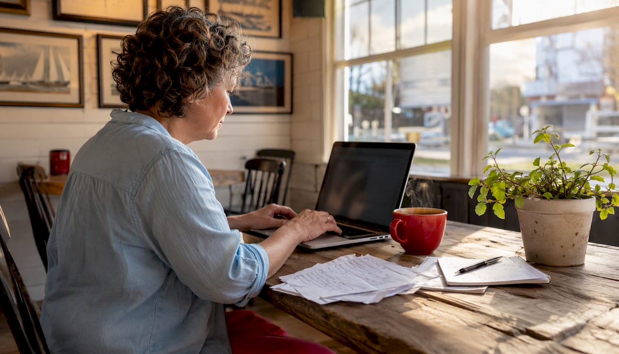 Woman installing OpenCPN software at home desk