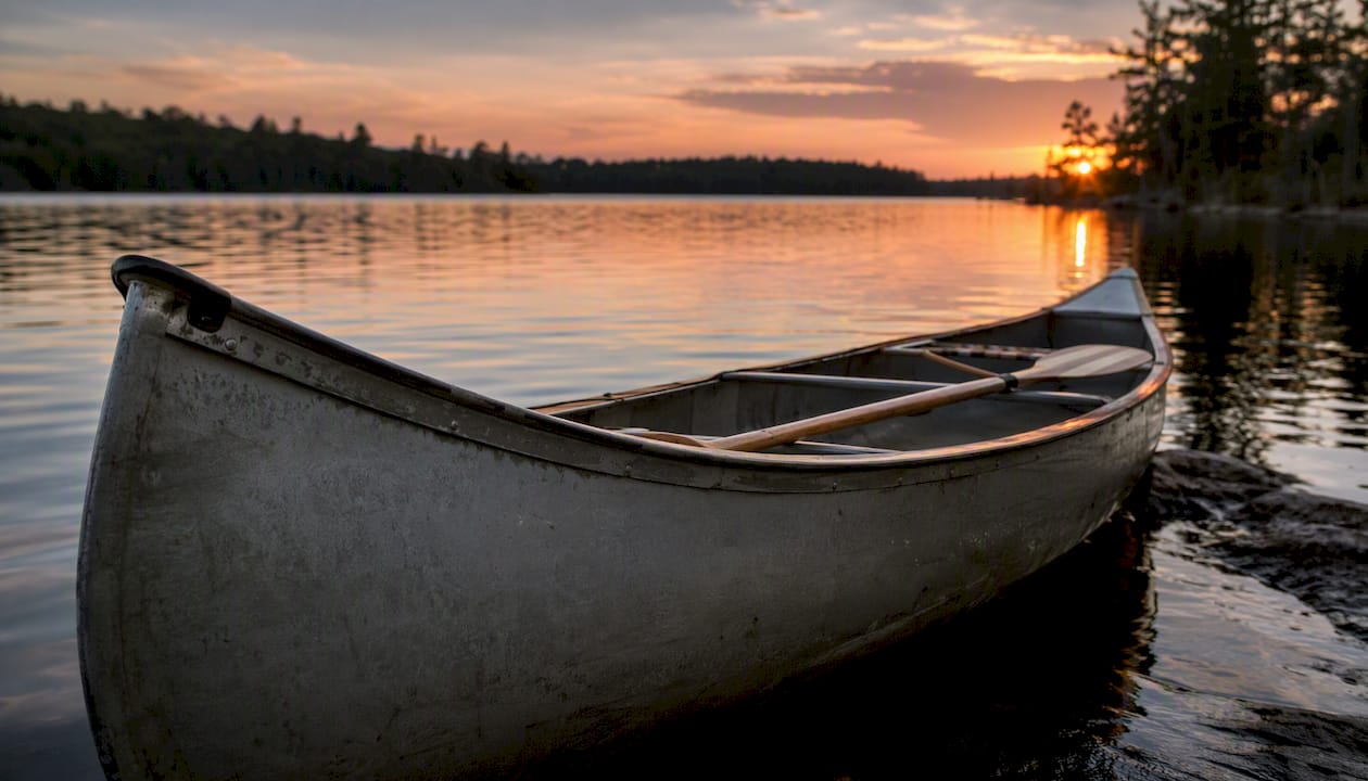 Canoe hull and gunwales on water