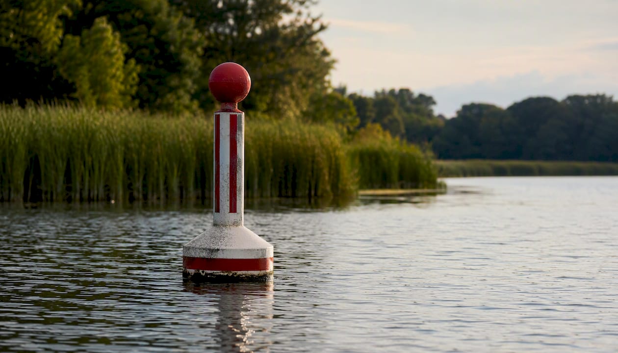 Safe water marker buoy with red white stripes