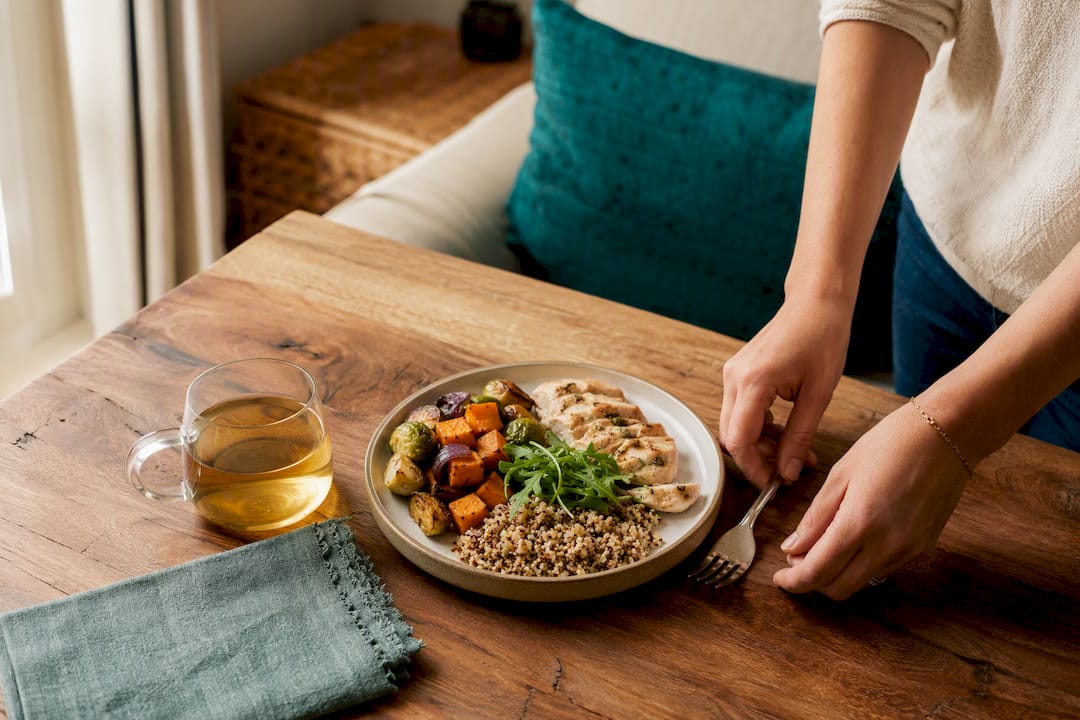 Hands placing fork down slowly by balanced meal