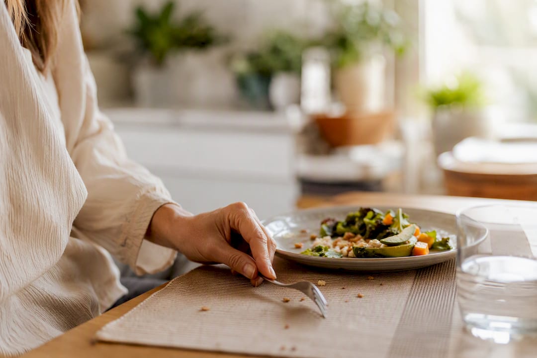 Hand placing fork down slowly during meal pause