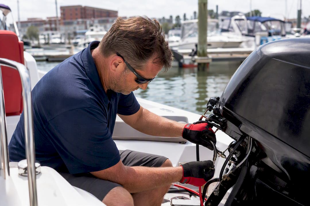 Hands inspecting boat safety kill switch