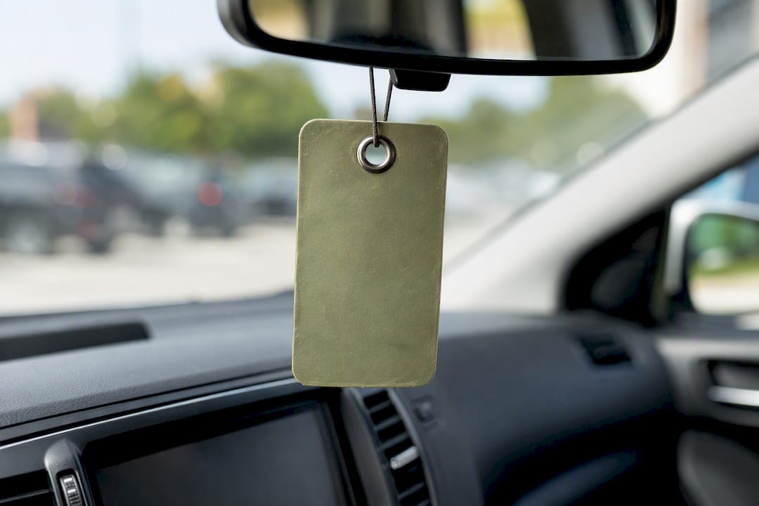 Parking hang tag with reinforced metal eyelet