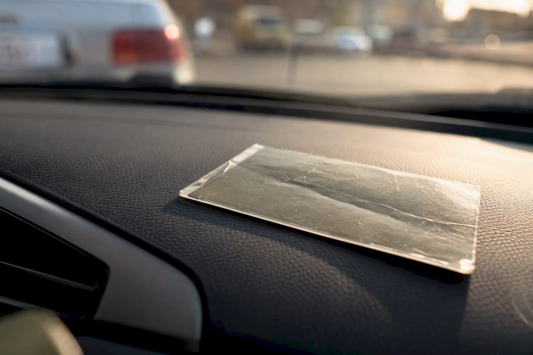 Parking permit on dashboard in bright sunlight showing wear
