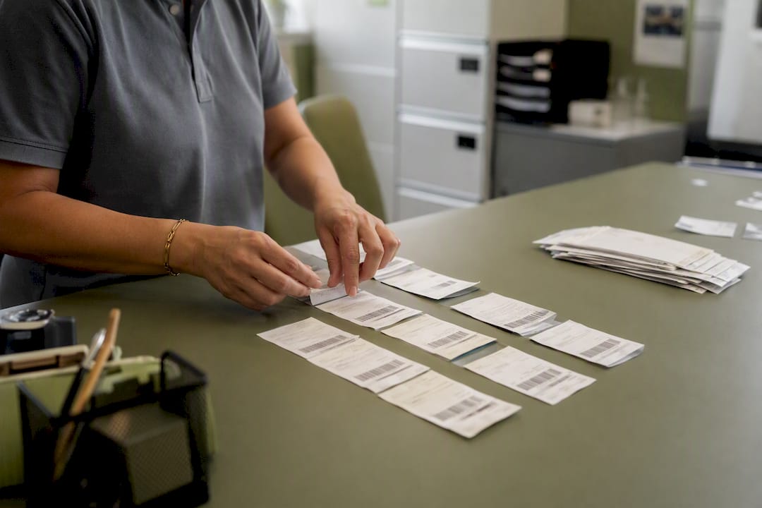 Hands inspecting parking tickets in booth