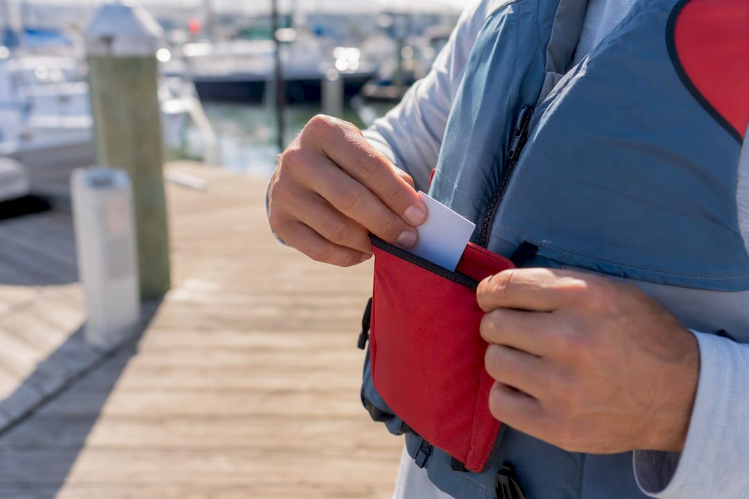 Boater attaching boating certification to life jacket