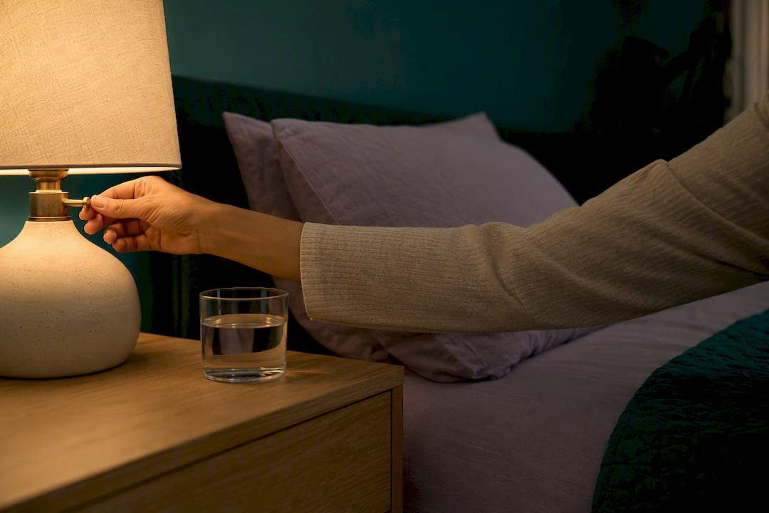 Hand dimming bedside lamp before sleep