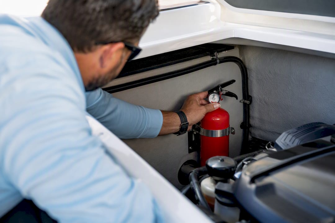 Boater checking marine fire extinguisher