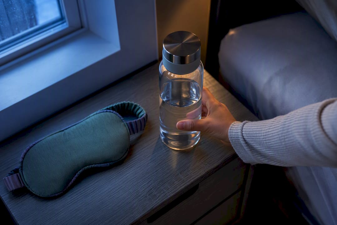 Filled water bottle placed on nightstand