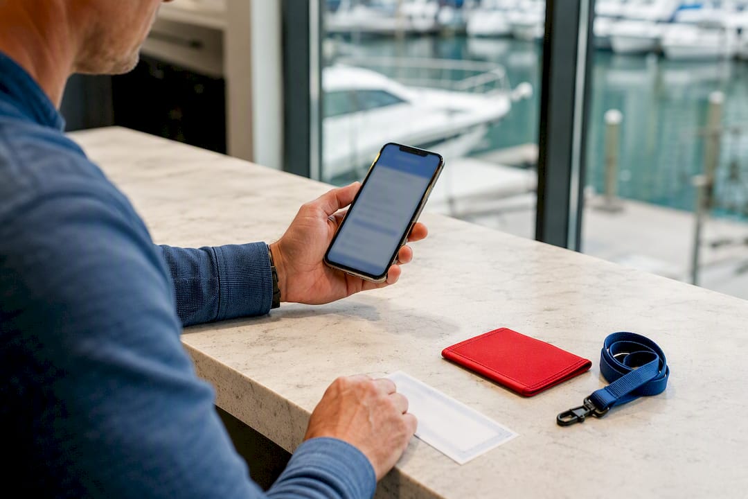 Boater photographing temporary certificate with phone