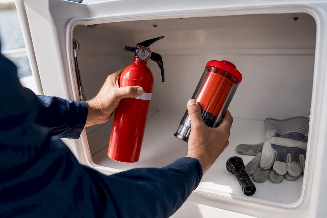 Hands inspecting marine safety equipment