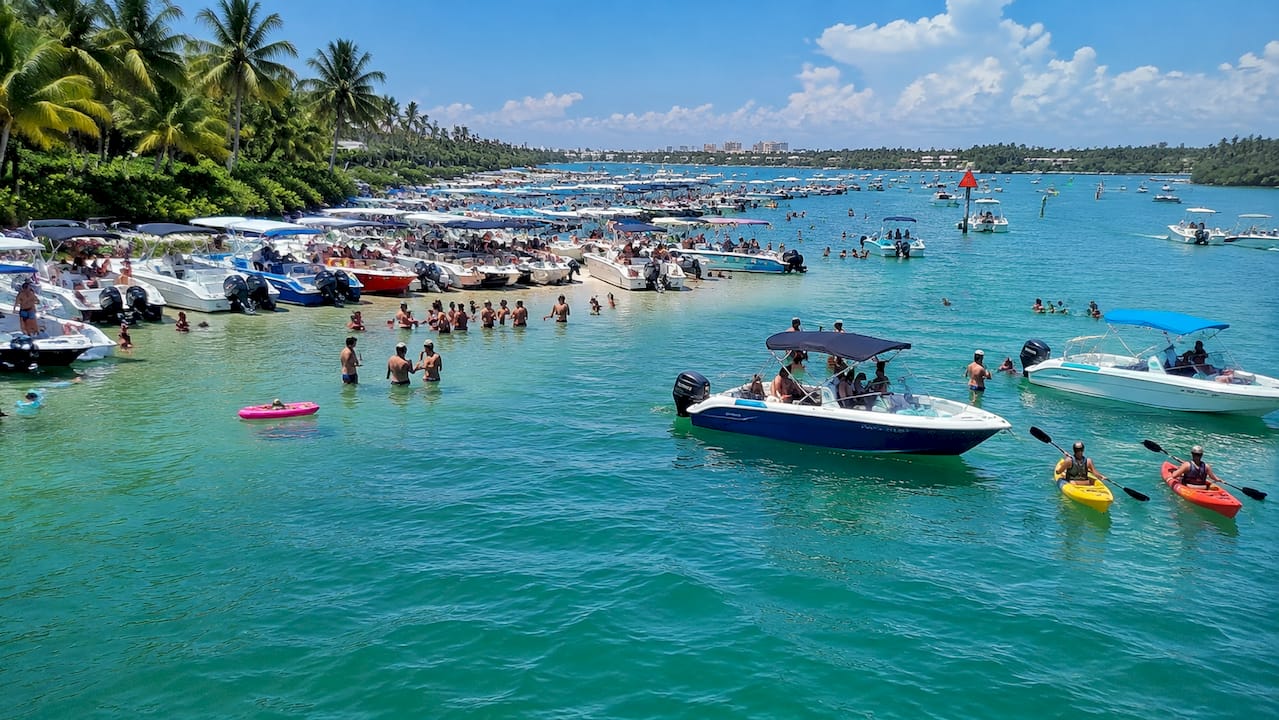 Aerial view of crowded Lake Boca sand bar showing boating hazards