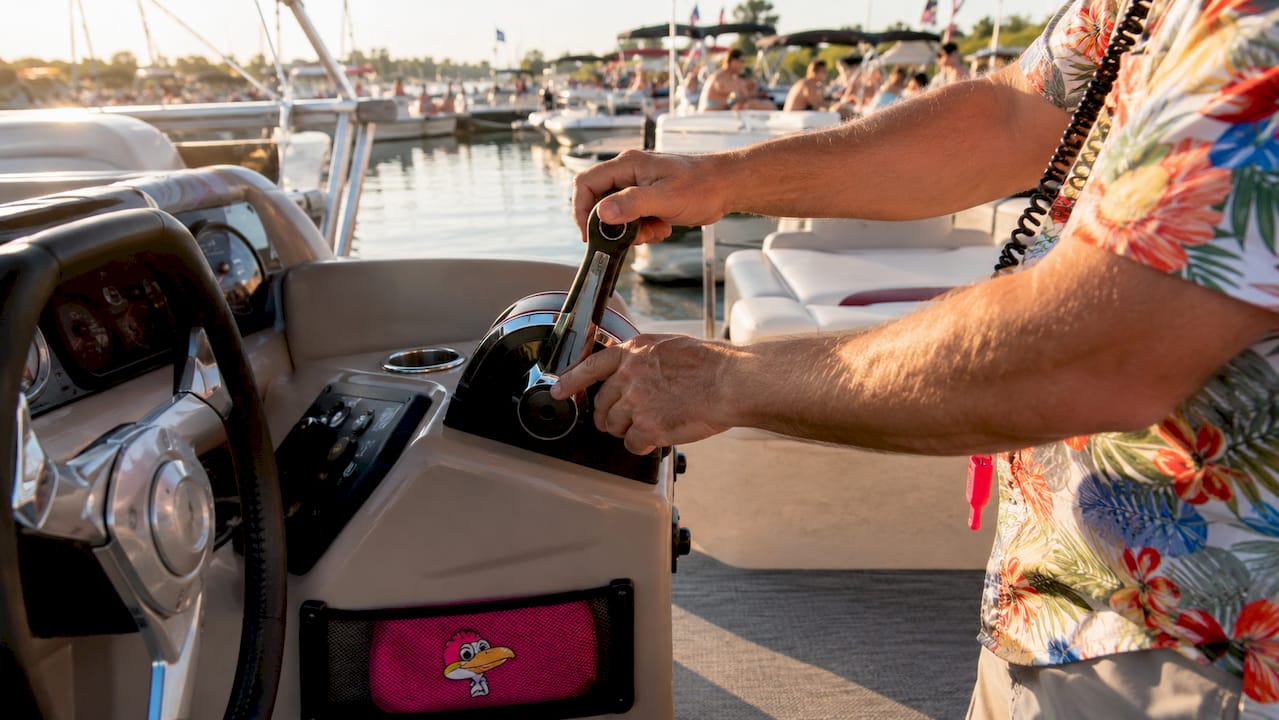 Hands pressing pontoon boat trim controls