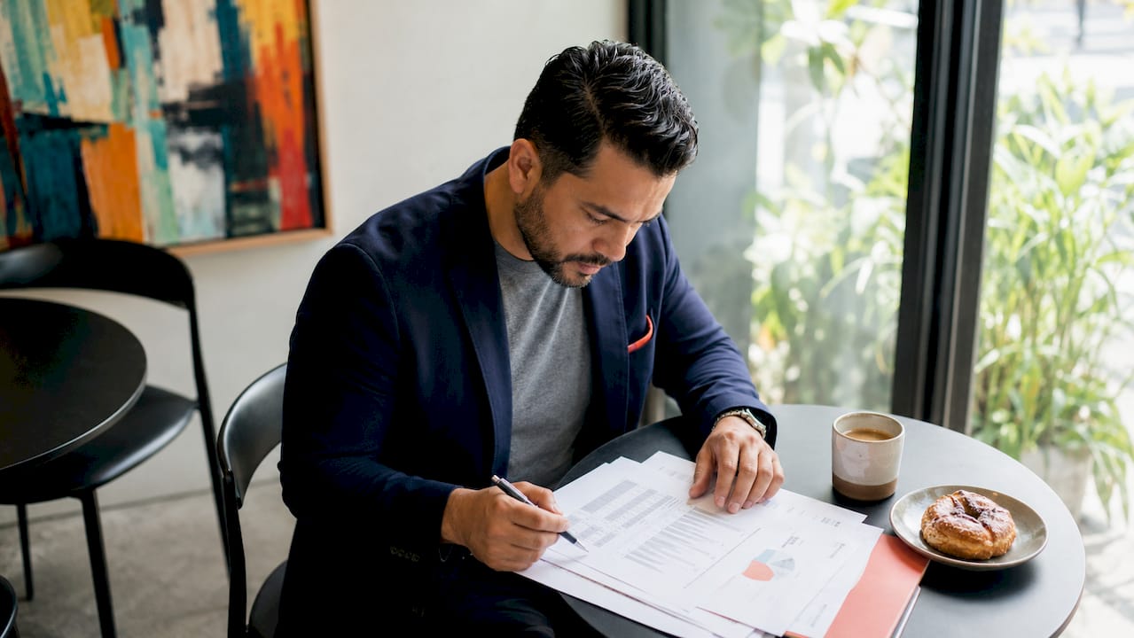 Man reviewing media buying contracts in office